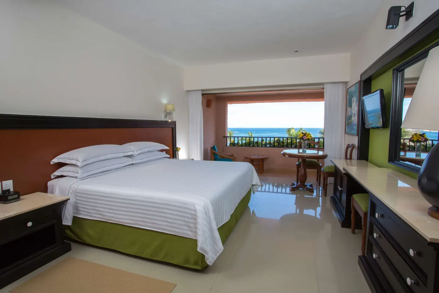 Deluxe Ocean View room with king bed and balcony at Barceló Huatulco.