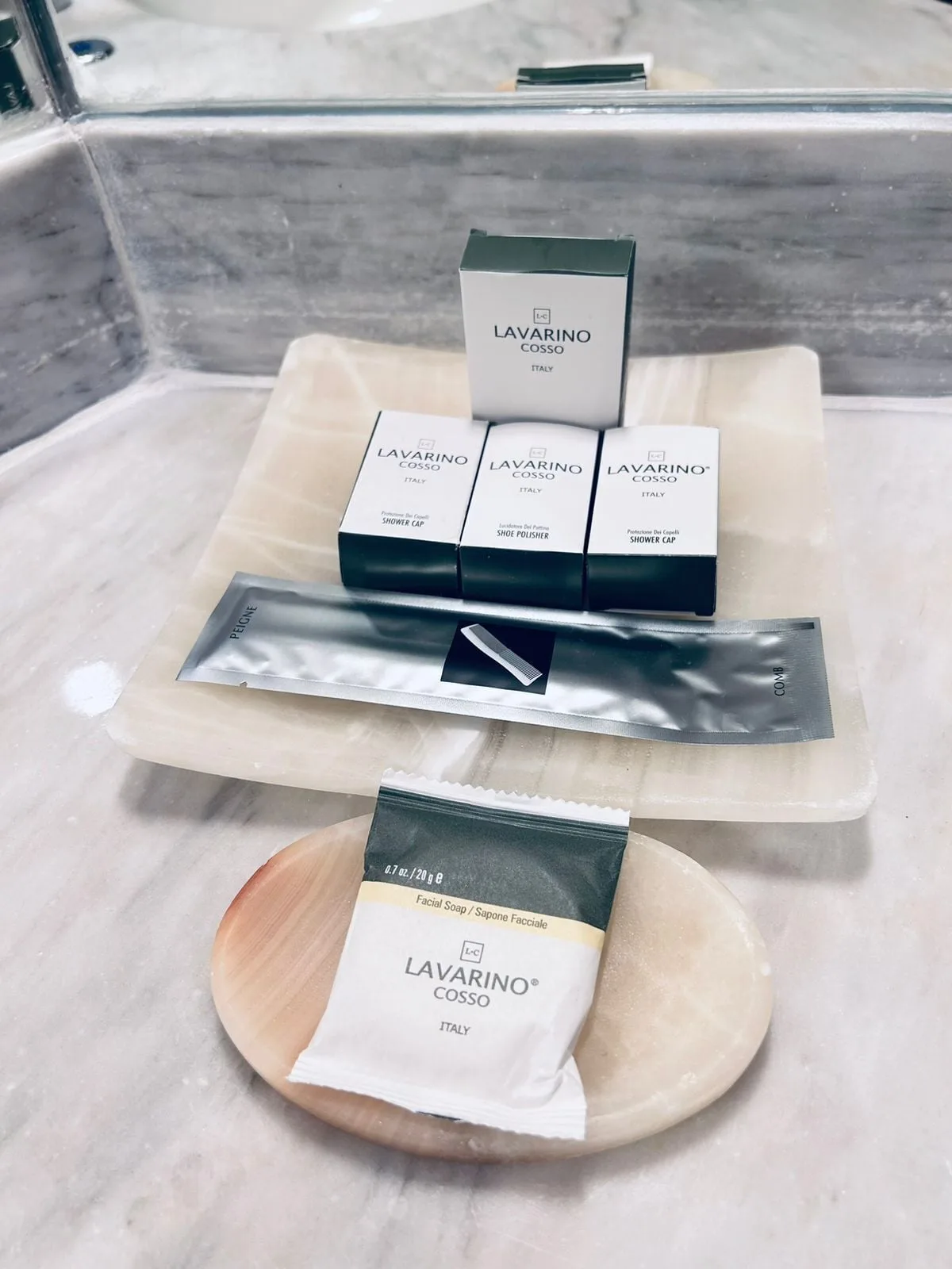Deluxe Room bath amenities at Barceló Huatulco arranged on a marble bathroom counter.