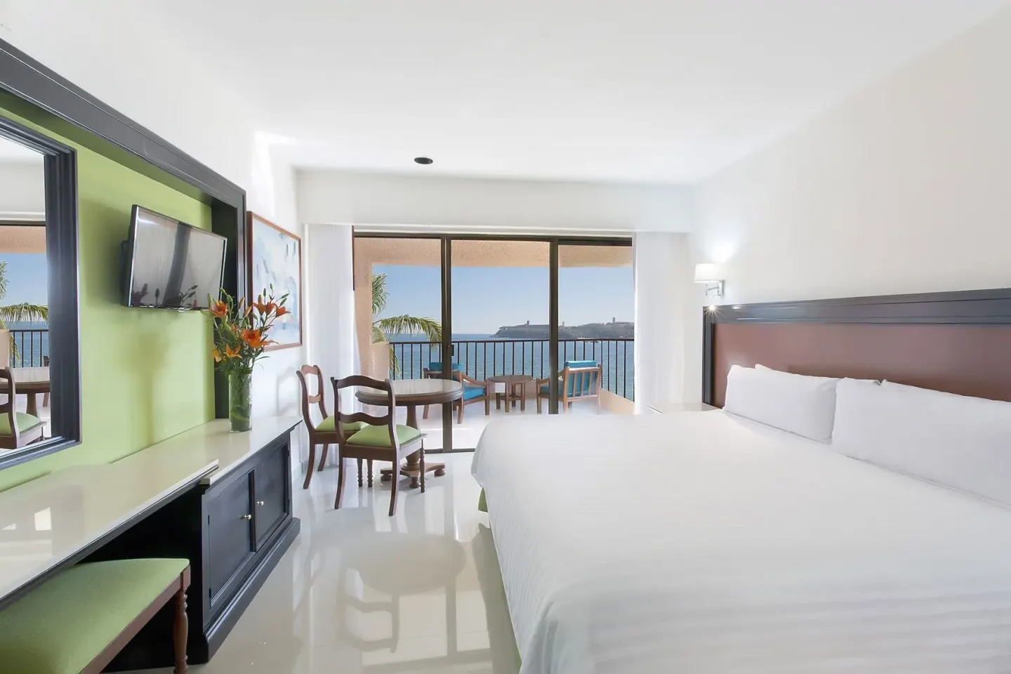 Premium Level Sea Front View Deluxe Suite king bed and balcony at Barceló Huatulco.