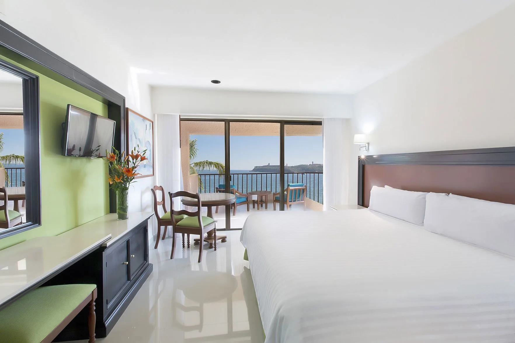 Premium Level Sea Front View Deluxe Suite king bed and balcony at Barceló Huatulco.