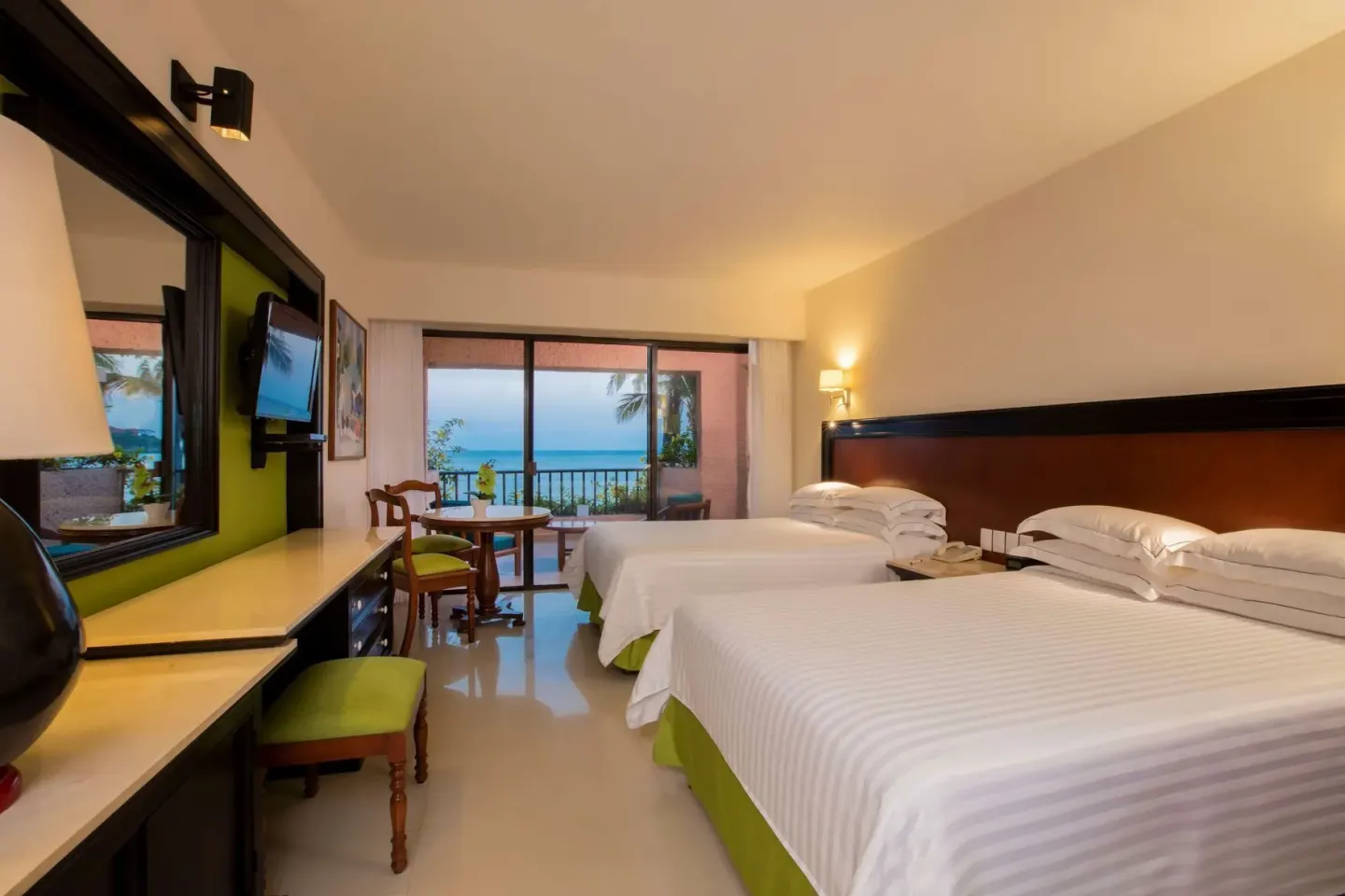 Premium Level Sea Front View Deluxe Suite with two beds and balcony at Barceló Huatulco.