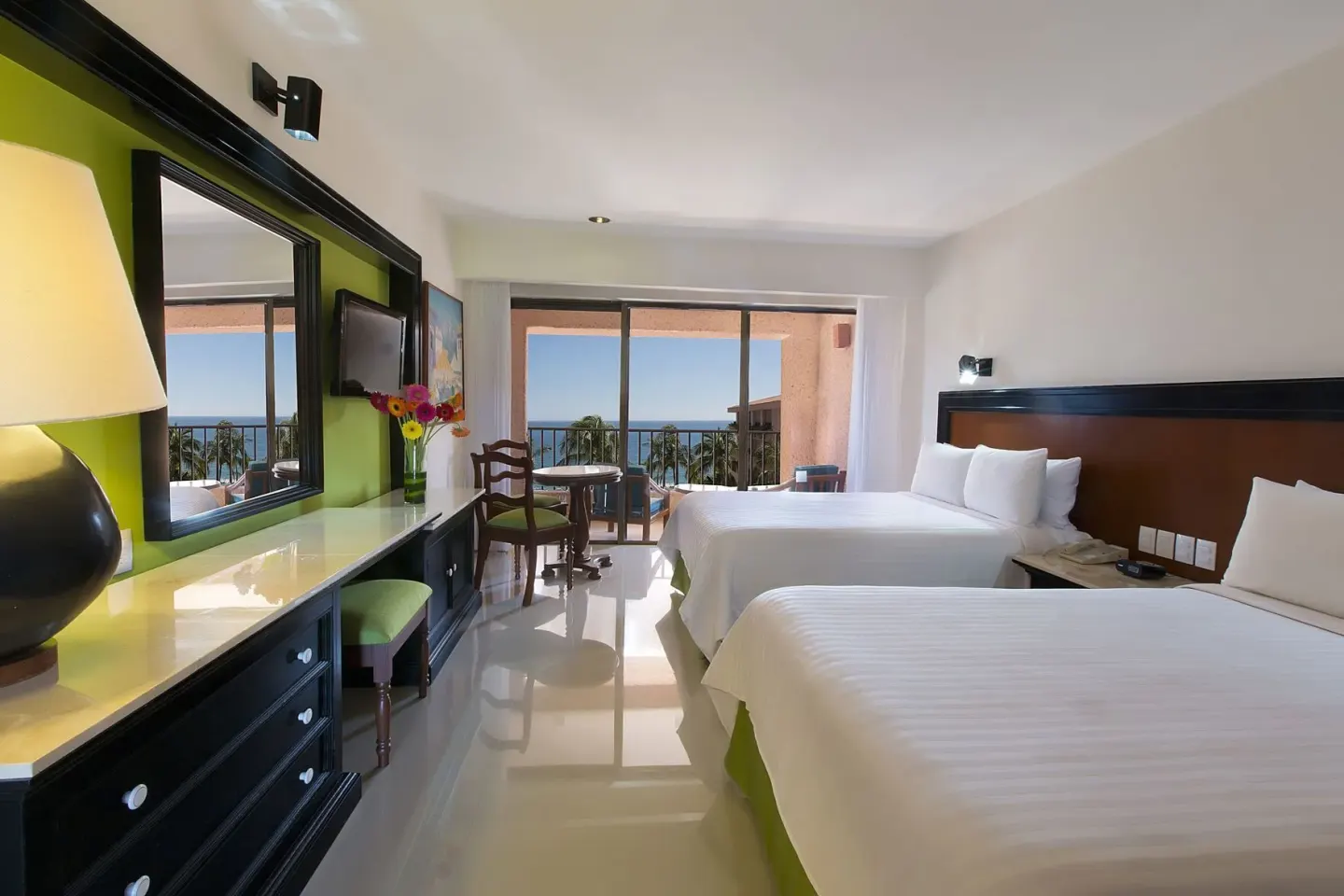 Premium Level Sea Front View Deluxe Suite with two beds and ocean-facing balcony at Barceló Huatulco.