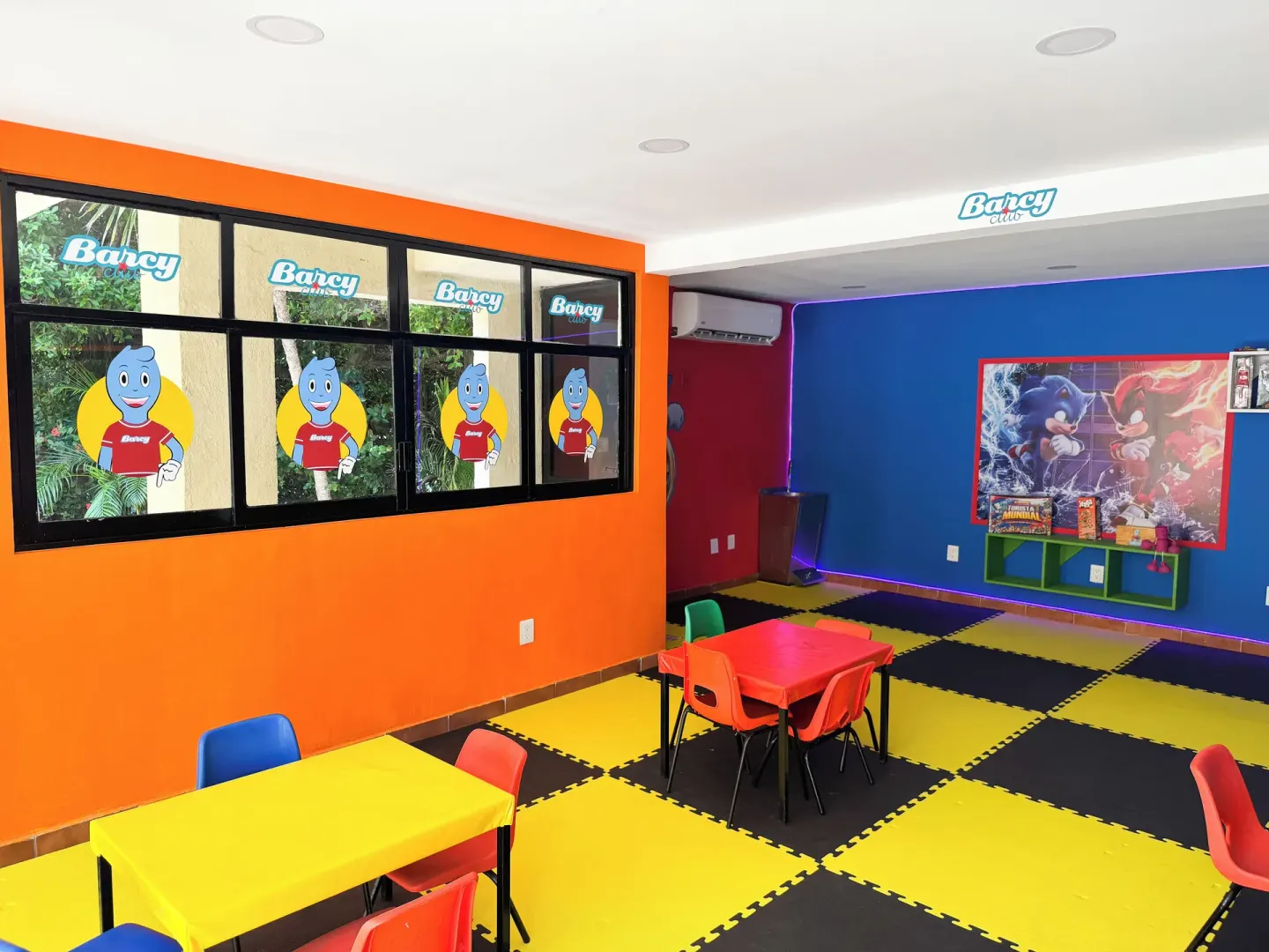 Children's club room with small tables, chairs, and bright floor mats at Barceló Ixtapa.