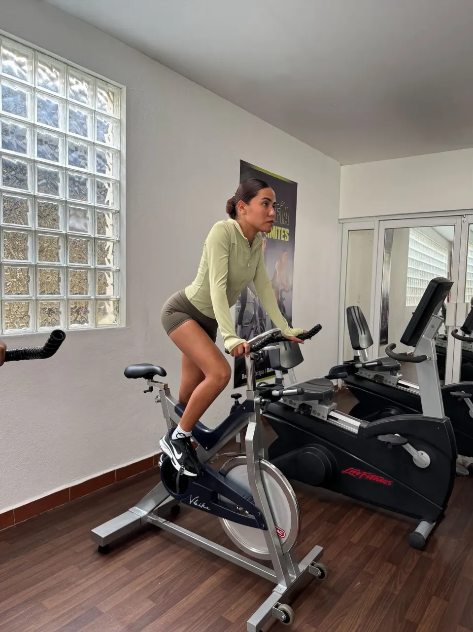 A guest rides a stationary bike in the fitness room at Barceló Ixtapa.