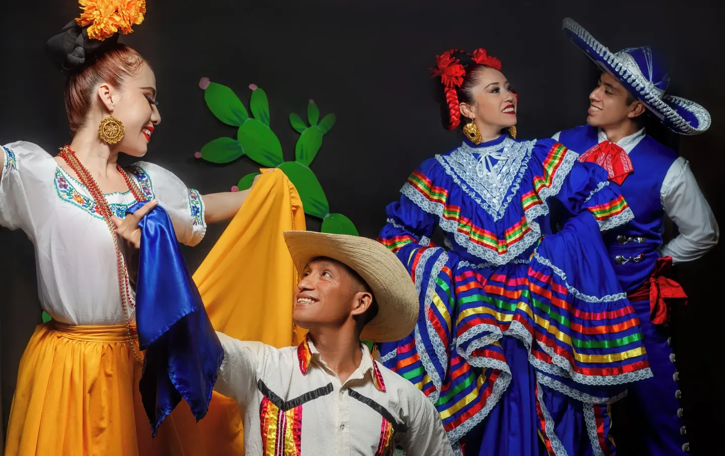 Four performers pose in colorful folkloric costumes at Barceló Ixtapa.