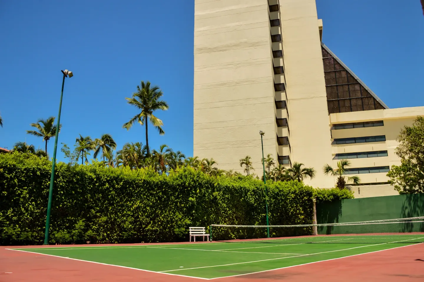 A tennis court sits beside the hotel tower at Barceló Ixtapa.