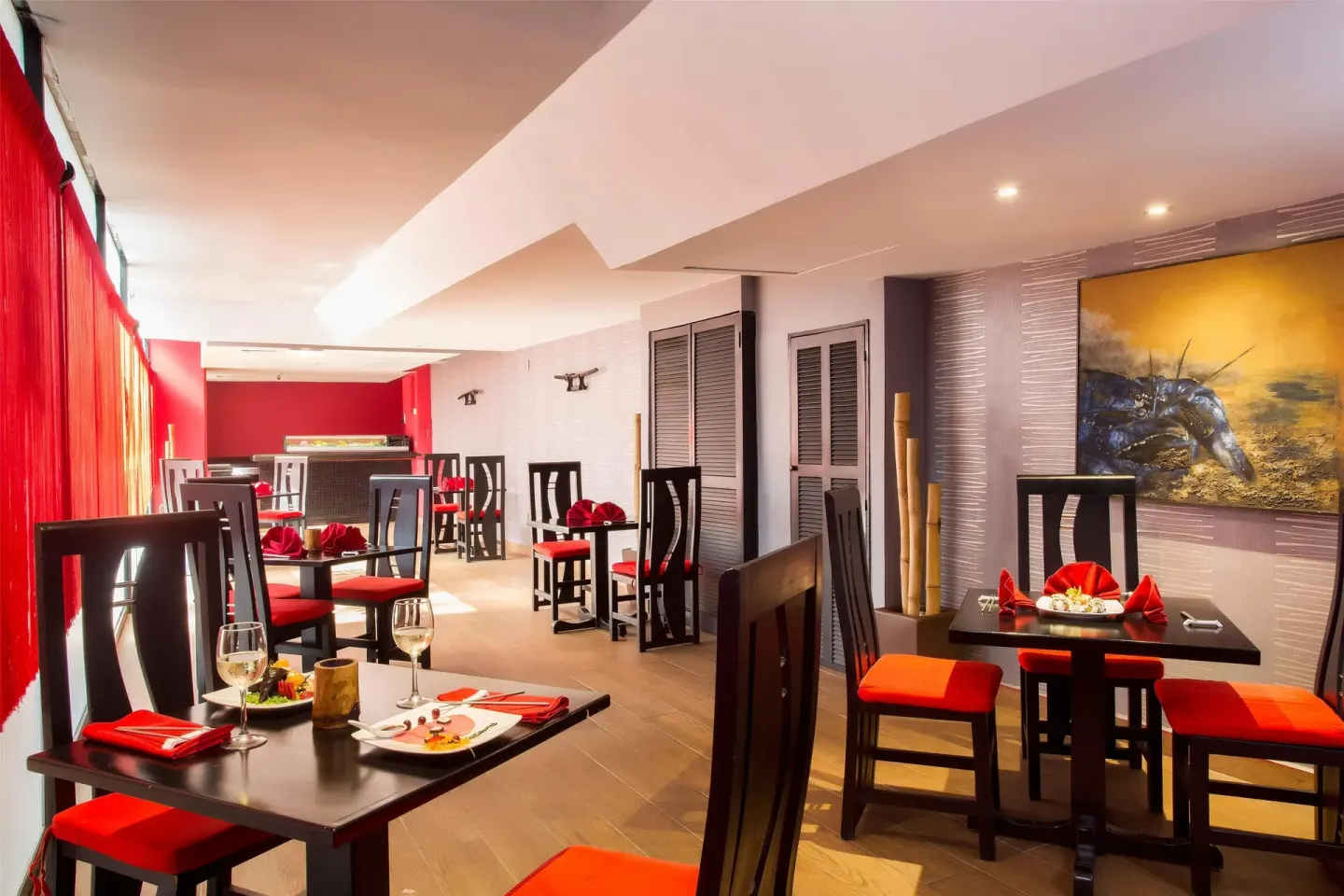 Red-accented Japanese dining room with set tables at Barceló Ixtapa.