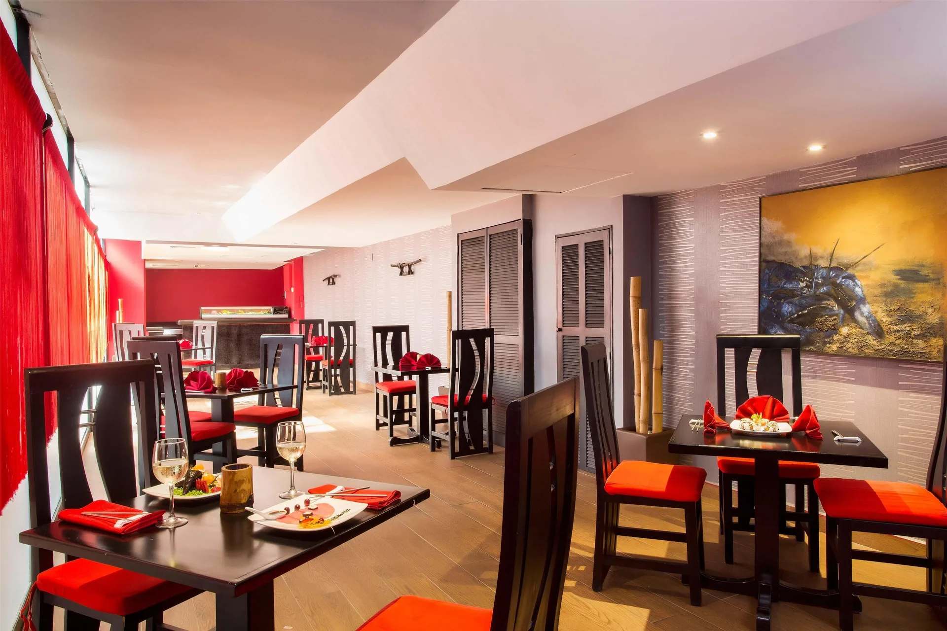 Red-accented Japanese dining room with set tables at Barceló Ixtapa.
