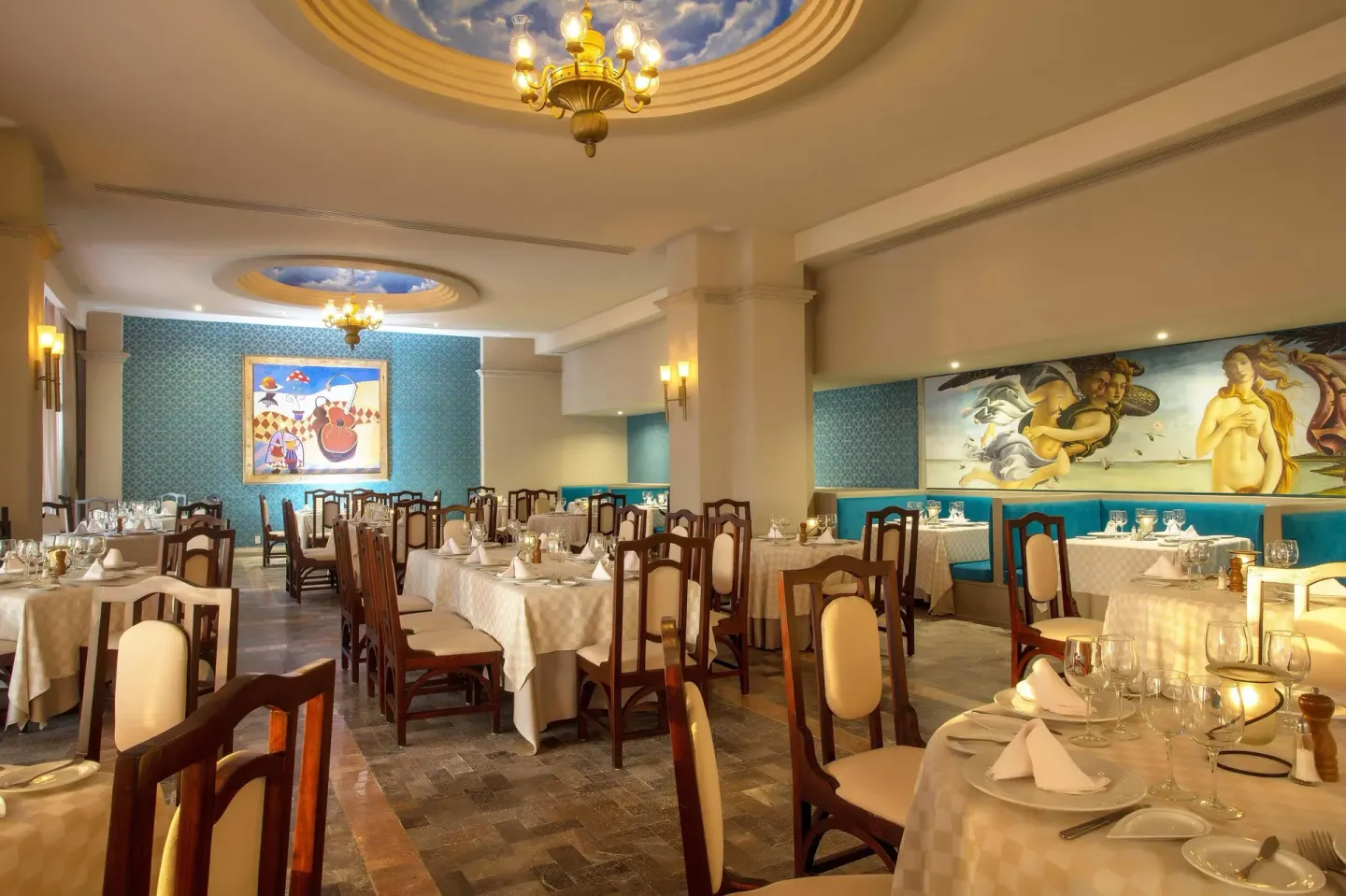 Italian-style dining room with murals and chandeliers at Barceló Ixtapa.