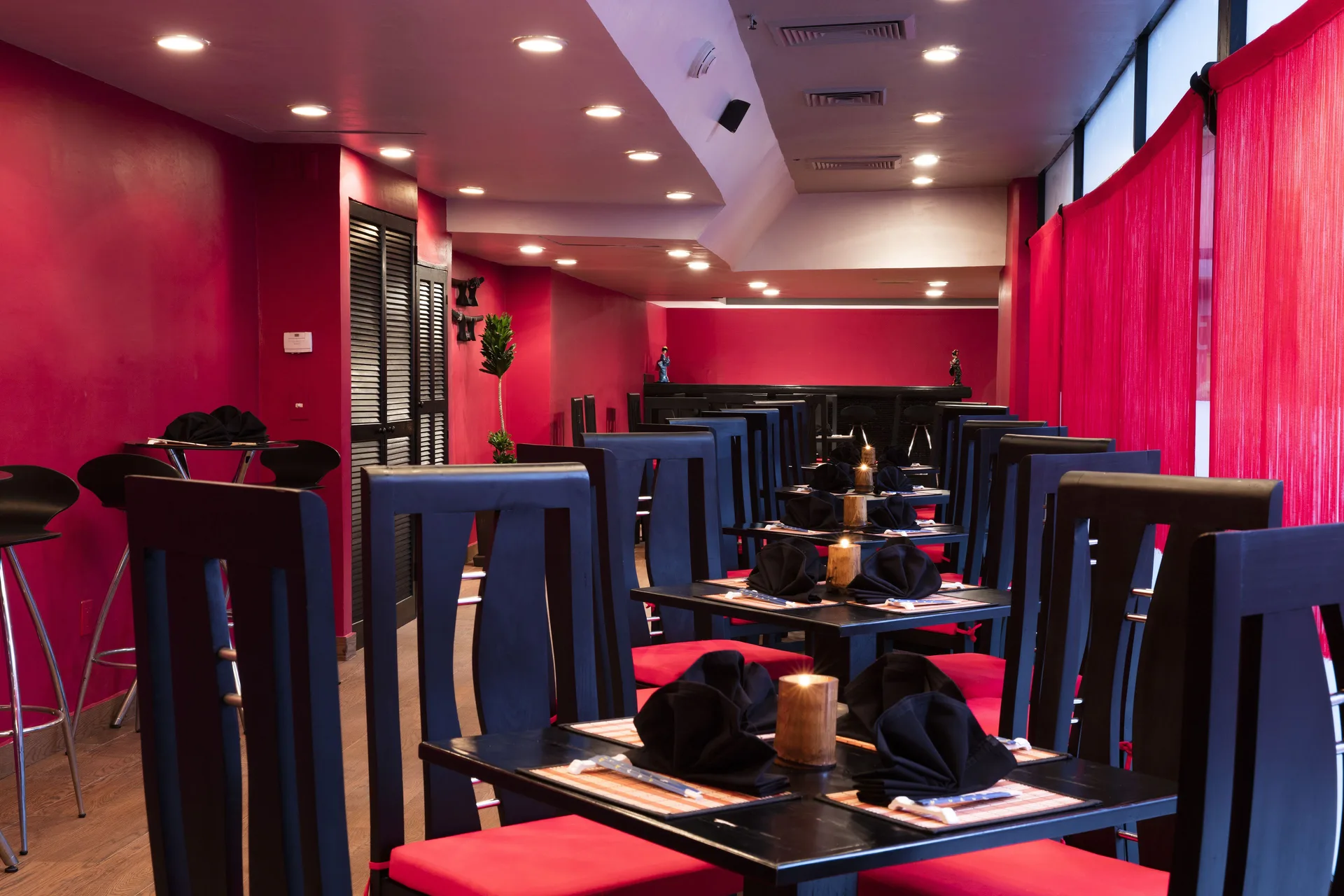 Red and black dining room with set tables at Barceló Ixtapa.