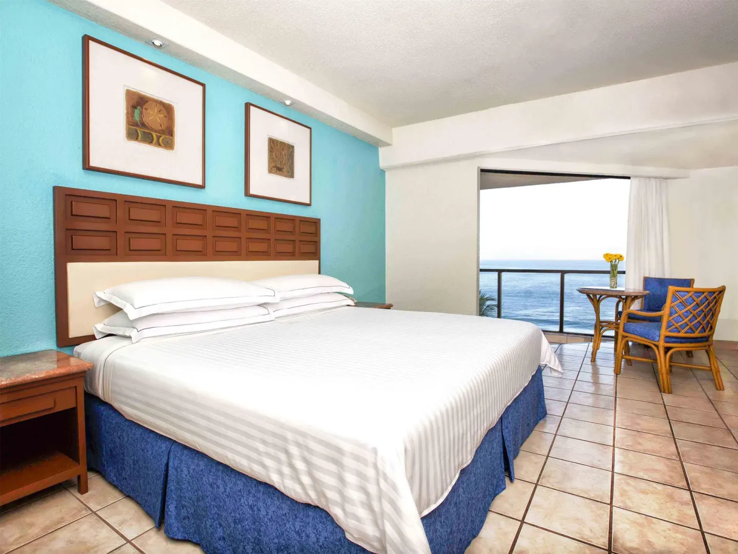 Superior Room Sea View with king bed, balcony seating and ocean view at Barceló Ixtapa.