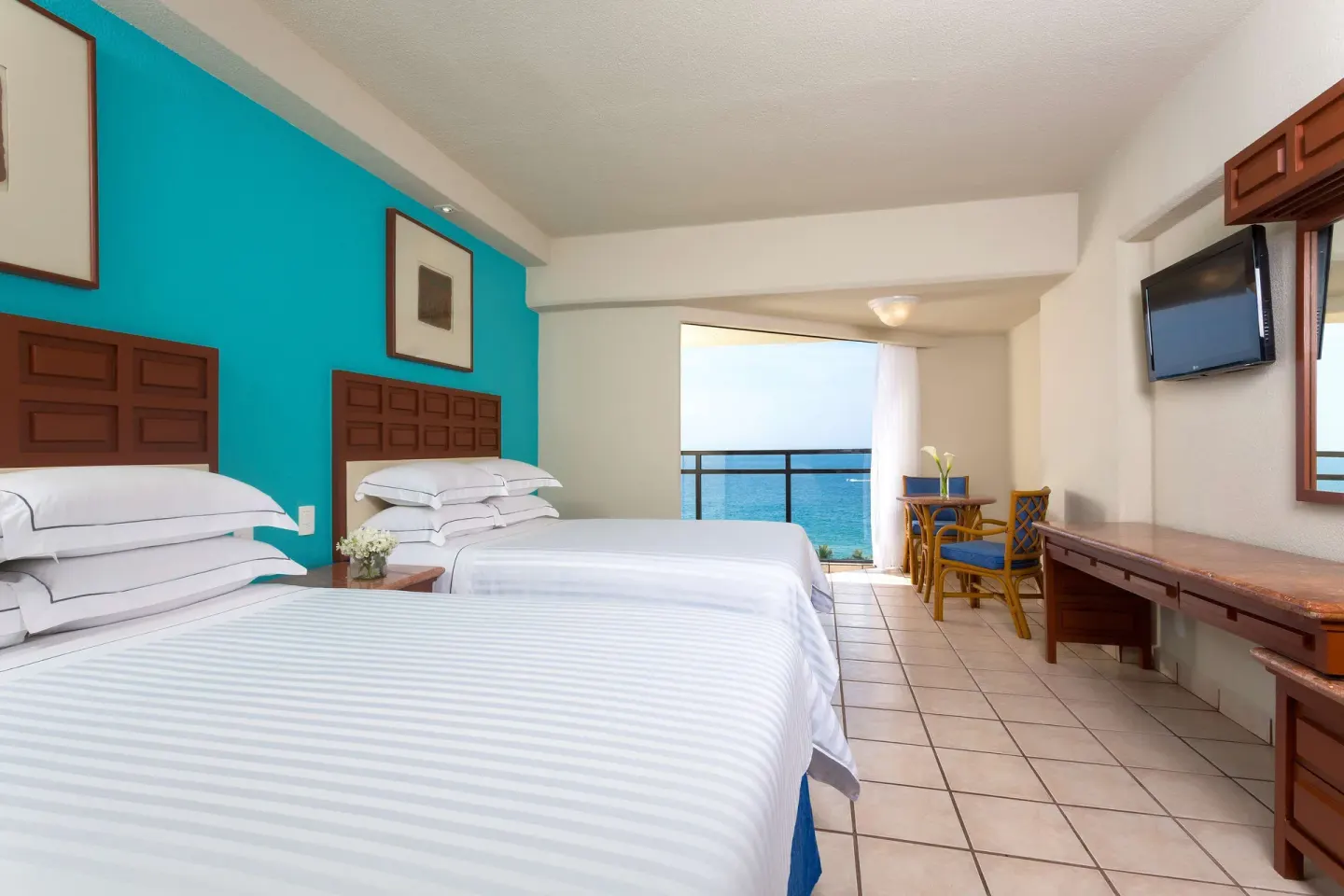 Superior Room Sea View with two beds, balcony ocean view and wall TV at Barceló Ixtapa.