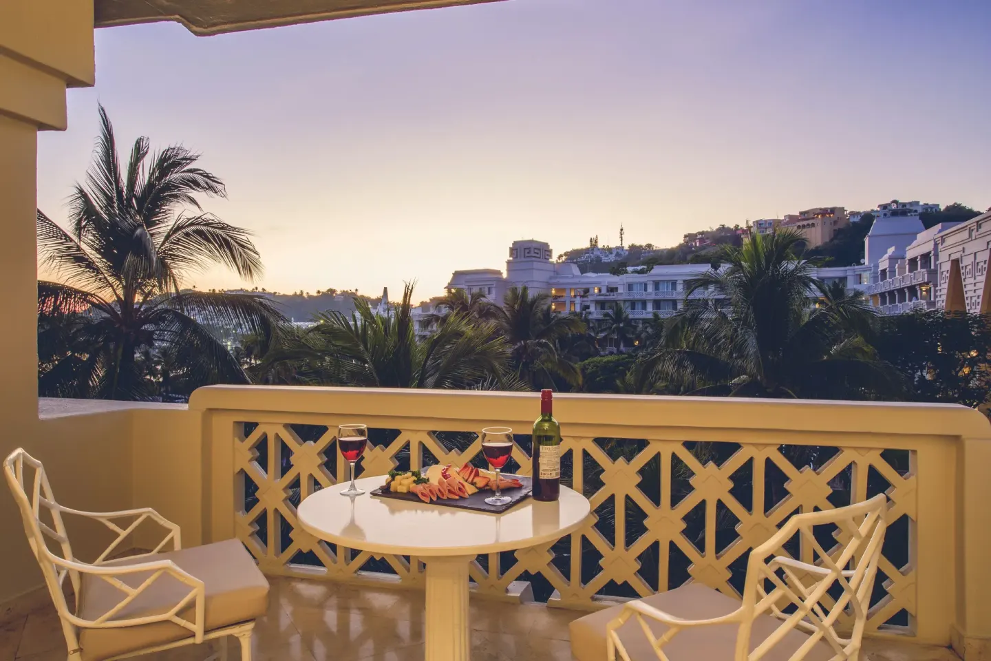 Balcony table with wine glasses and snacks at Barceló Karmina.