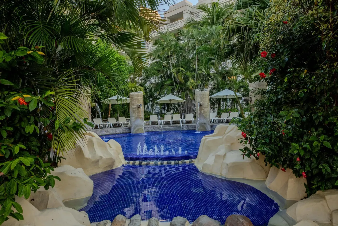 Garden pool with fountains and loungers at Barceló Karmina.