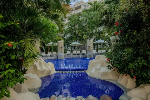 Garden pool with fountains and loungers at Barceló Karmina.