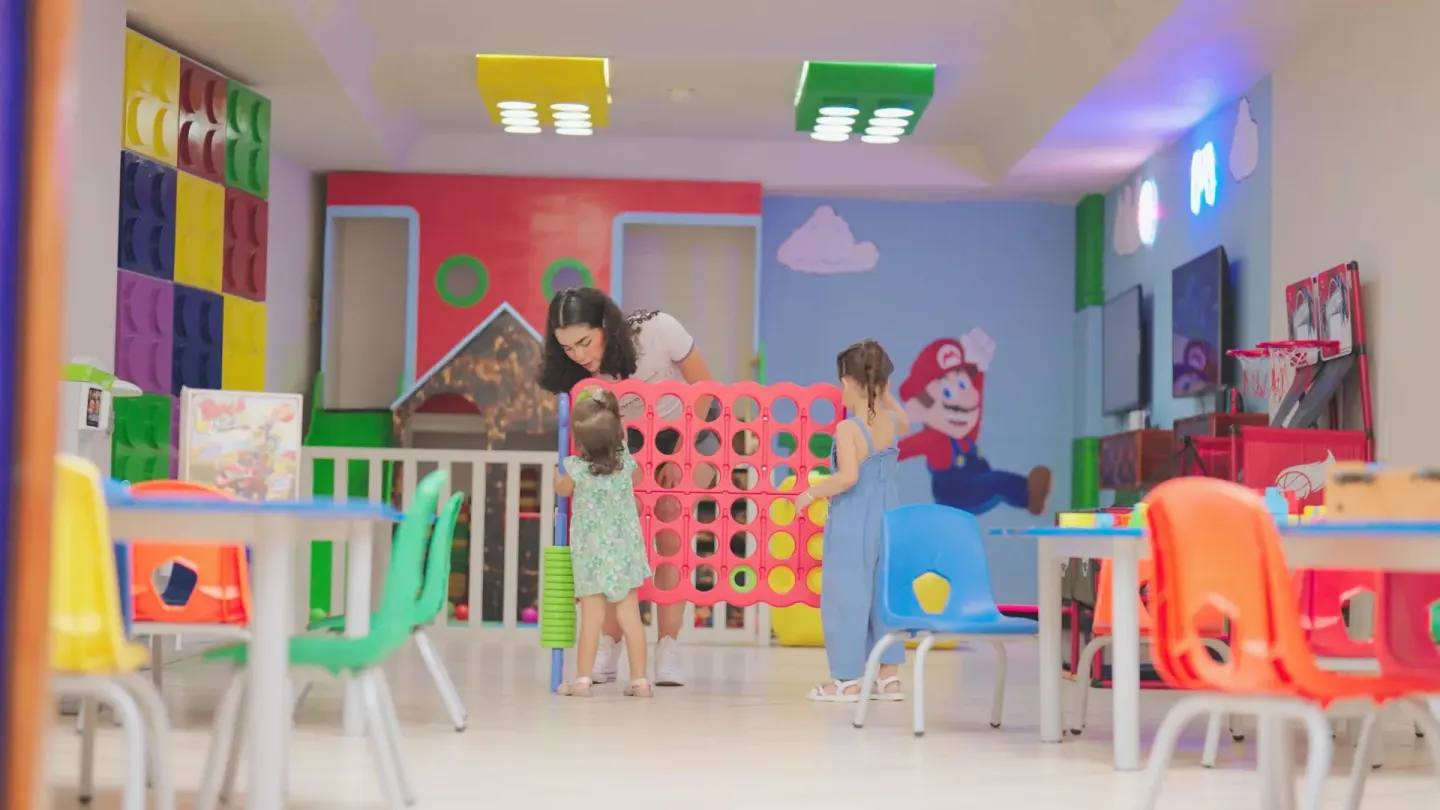 Children play a giant connect game inside the kids' club at Barceló Karmina.