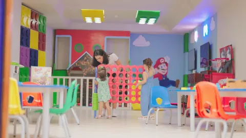 Children play a giant connect game inside the kids' club at Barceló Karmina.