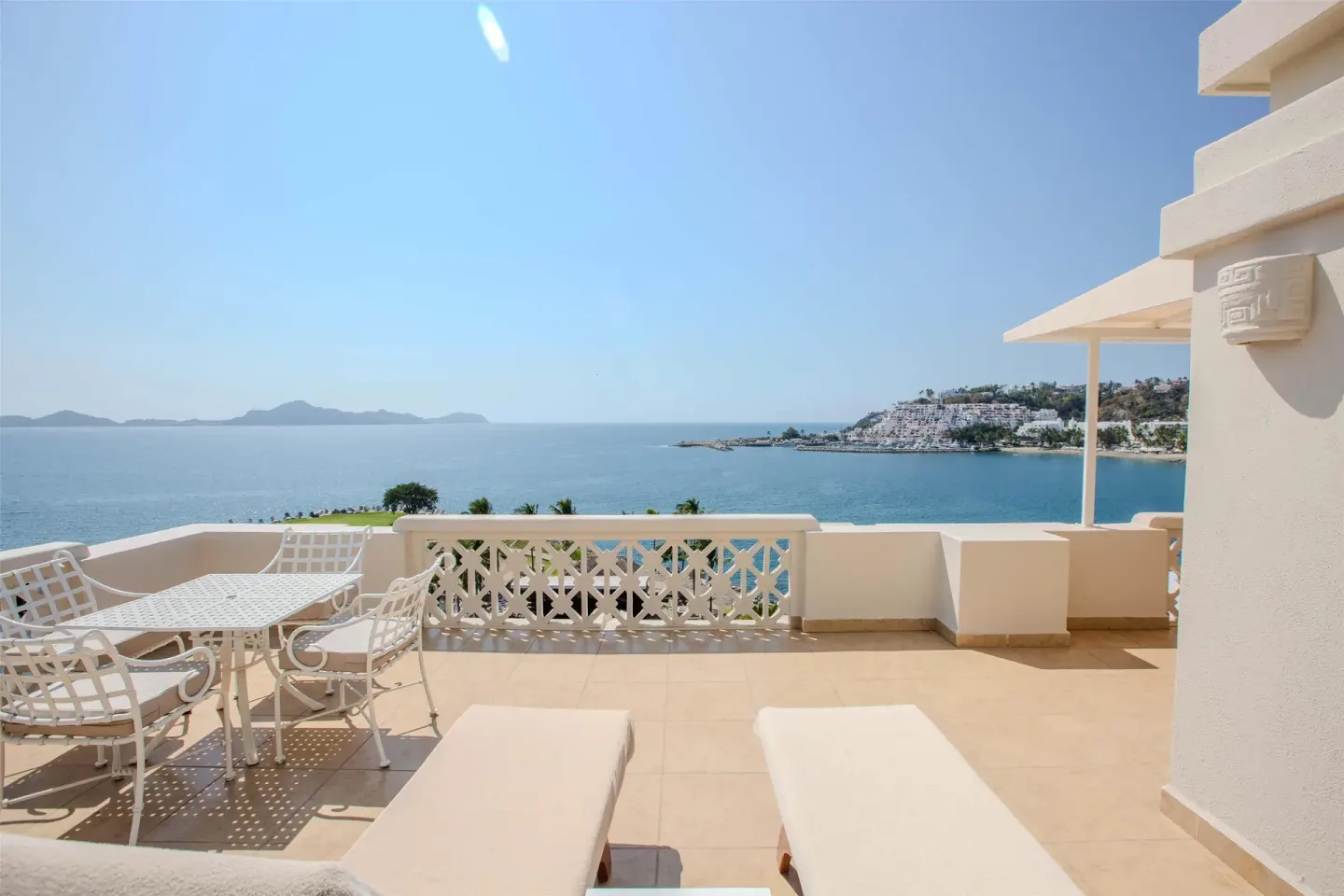 Ocean-view terrace with loungers and dining set at Barceló Karmina.