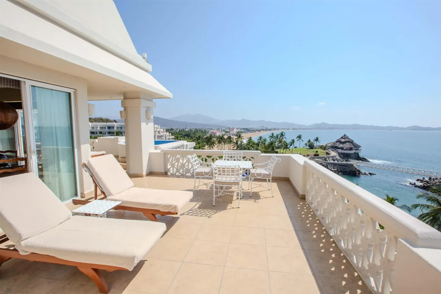 Ocean-view terrace with loungers and dining set at Barceló Karmina.