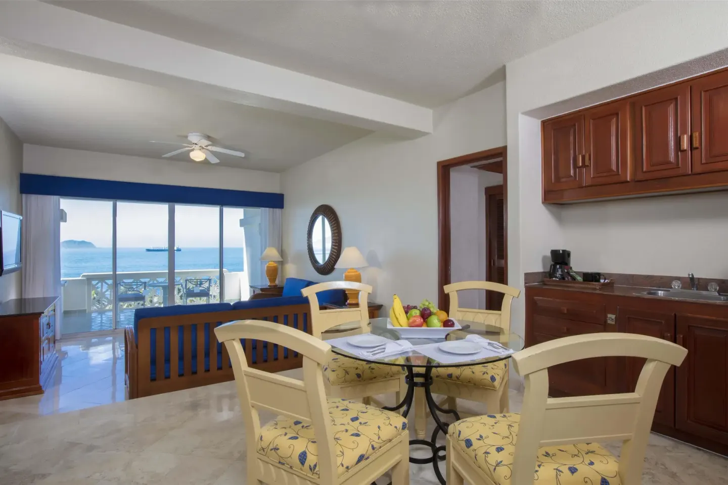 Suite living and dining area with ocean-facing balcony at Barceló Karmina.