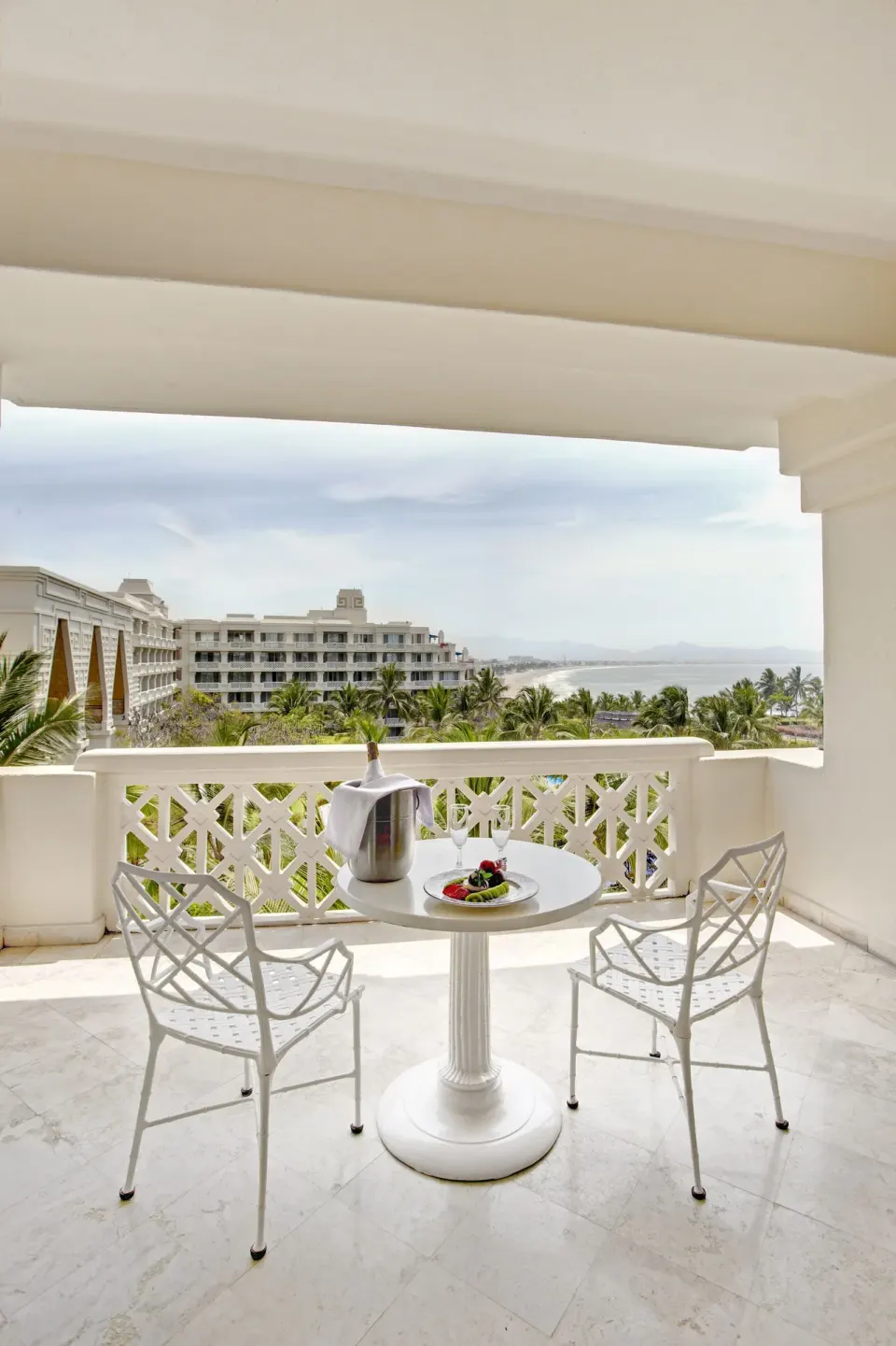 Junior Suite Sea View balcony at Barceló Karmina with table, two chairs and ocean view.
