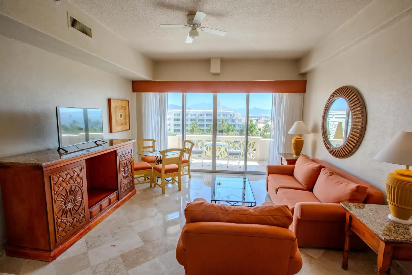 Junior Suite Sea View lounge at Barceló Karmina with peach seating and balcony doors.