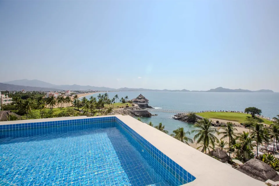 Blue-tiled private pool with panoramic ocean and coastline views at Barceló Karmina.