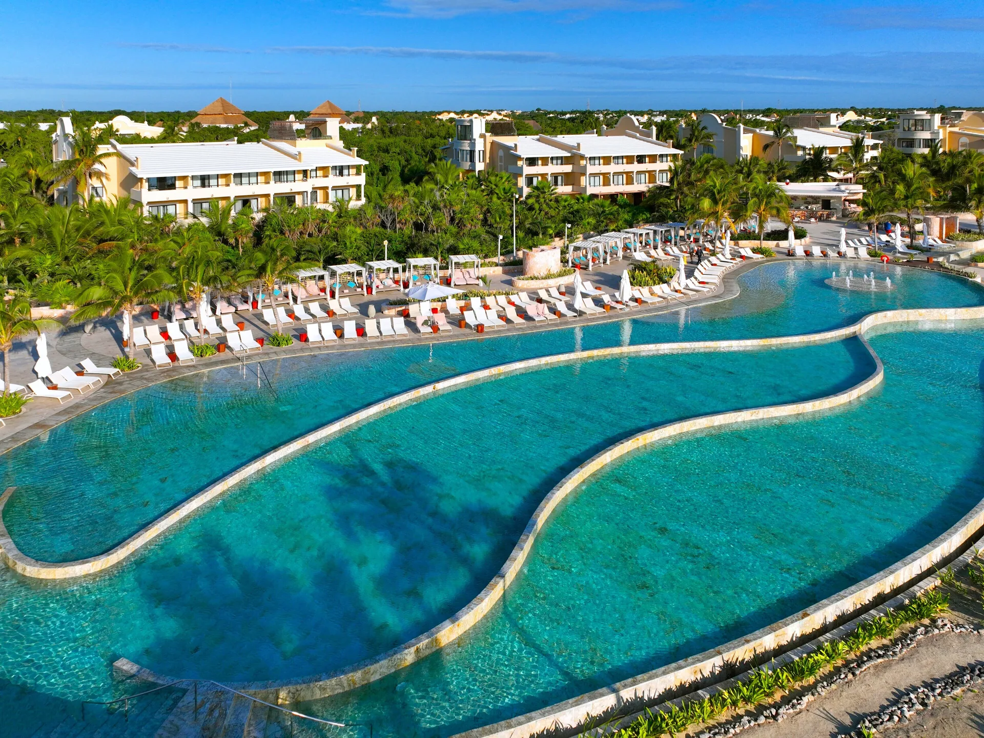 TRS Yucatan Hotel adults-only all-inclusive resort in Xpu-Ha with luxury suites, beachfront pools, and refined atmosphere.
