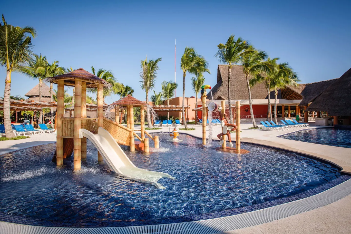 Children’s pool with play structure, slide, and water sprays at Barceló Maya Caribe.