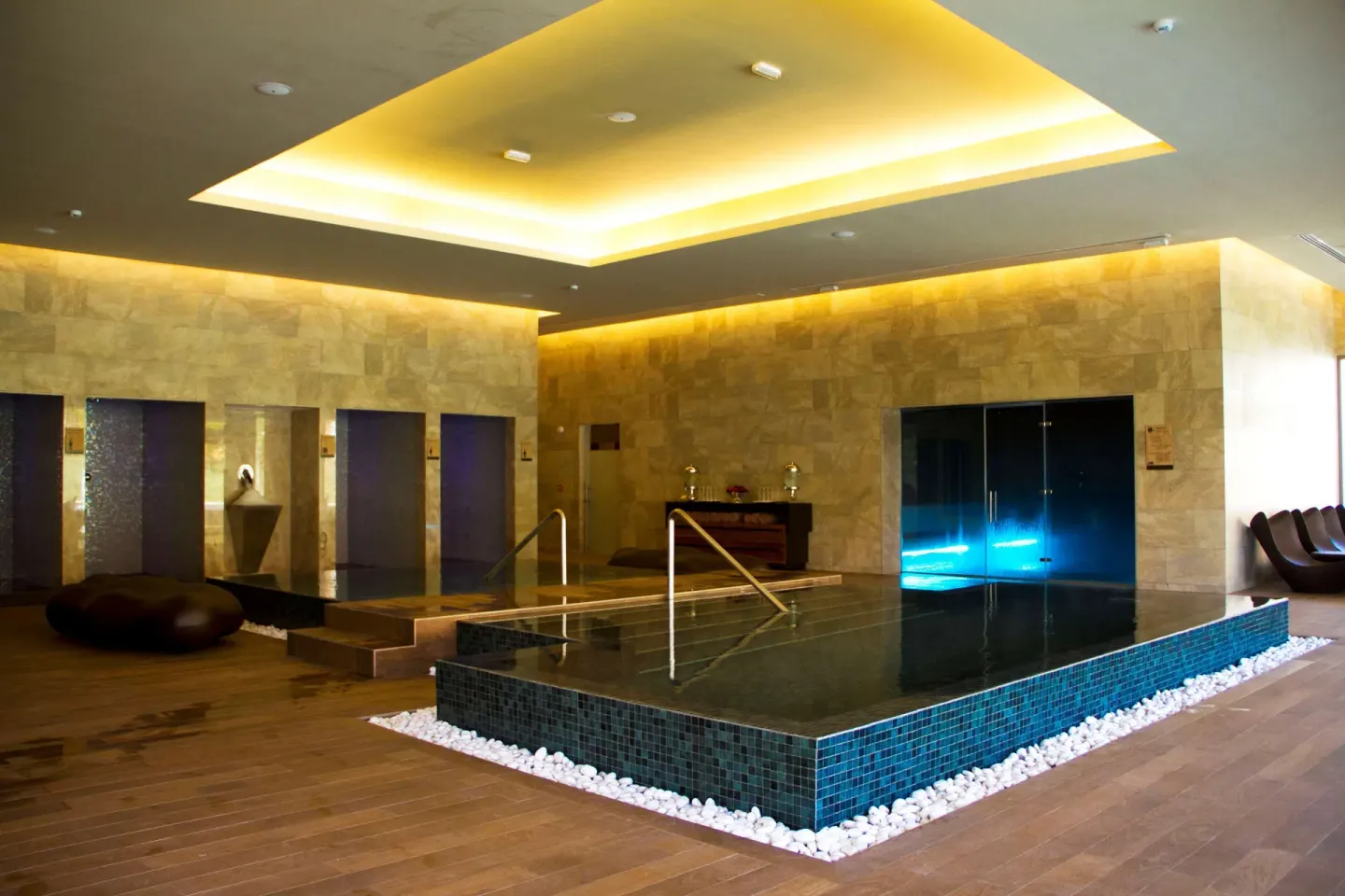 Modern indoor spa hydrotherapy pool with stone walls at Barceló Maya Caribe.