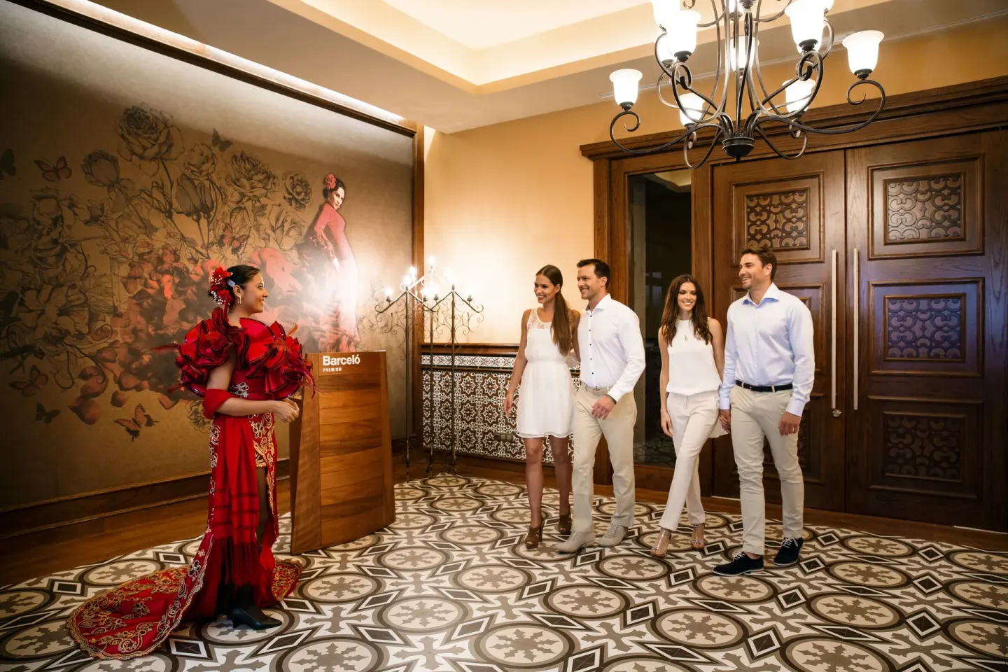 Spanish-themed restaurant entrance with guests and a hostess at Barceló Maya Caribe.