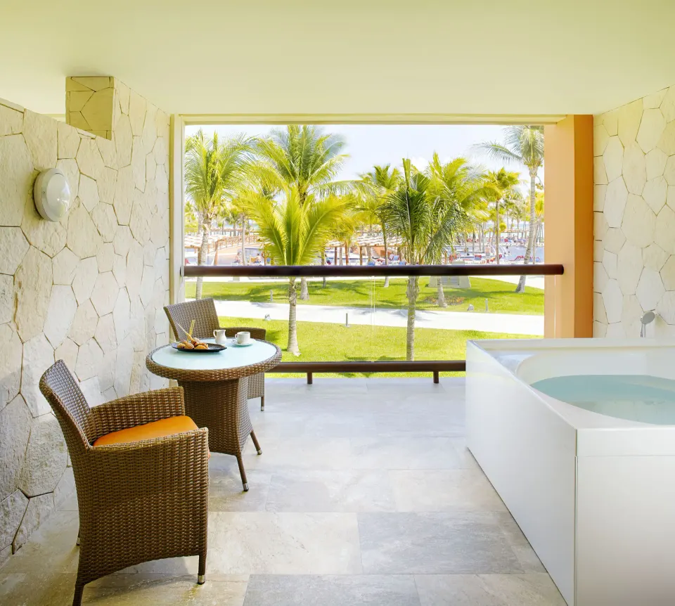 Junior Suite balcony with whirlpool tub and palm views at Barceló Maya Caribe.