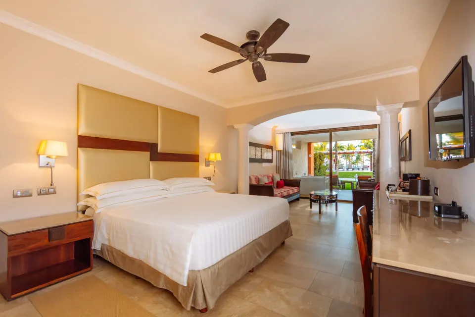 Junior Suite swim-up room with king bed and patio view at Barceló Maya Caribe.