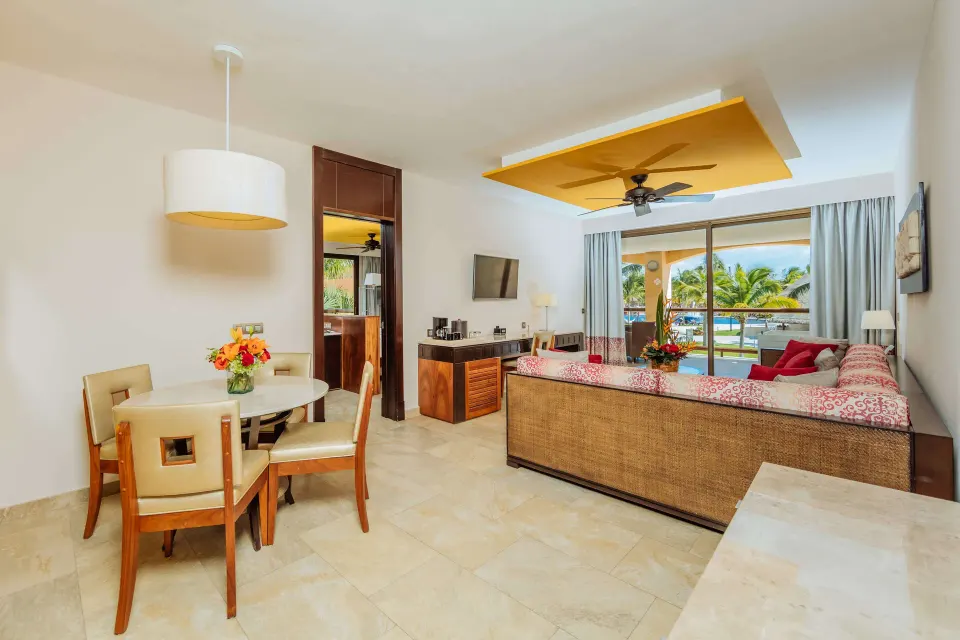 Ocean Front Premium Level suite living room with dining table at Barceló Maya Caribe.