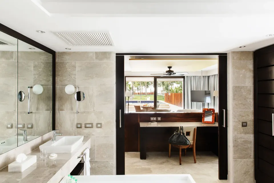 Suite bathroom vanity opening to the bedroom and terrace at Barceló Maya Caribe.