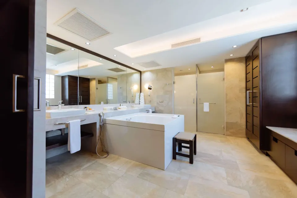 Suite bathroom with soaking tub, double vanity, and shower at Barceló Maya Caribe.