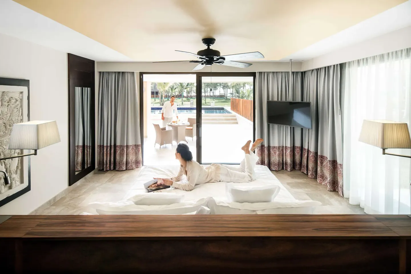 Suite Swim Up Premium Level bedroom with king bed and terrace at Barceló Maya Caribe.
