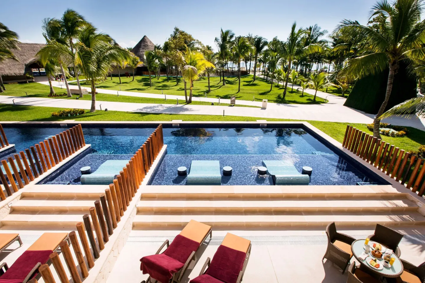 Swim-up suite terrace with loungers and pool view at Barceló Maya Caribe.