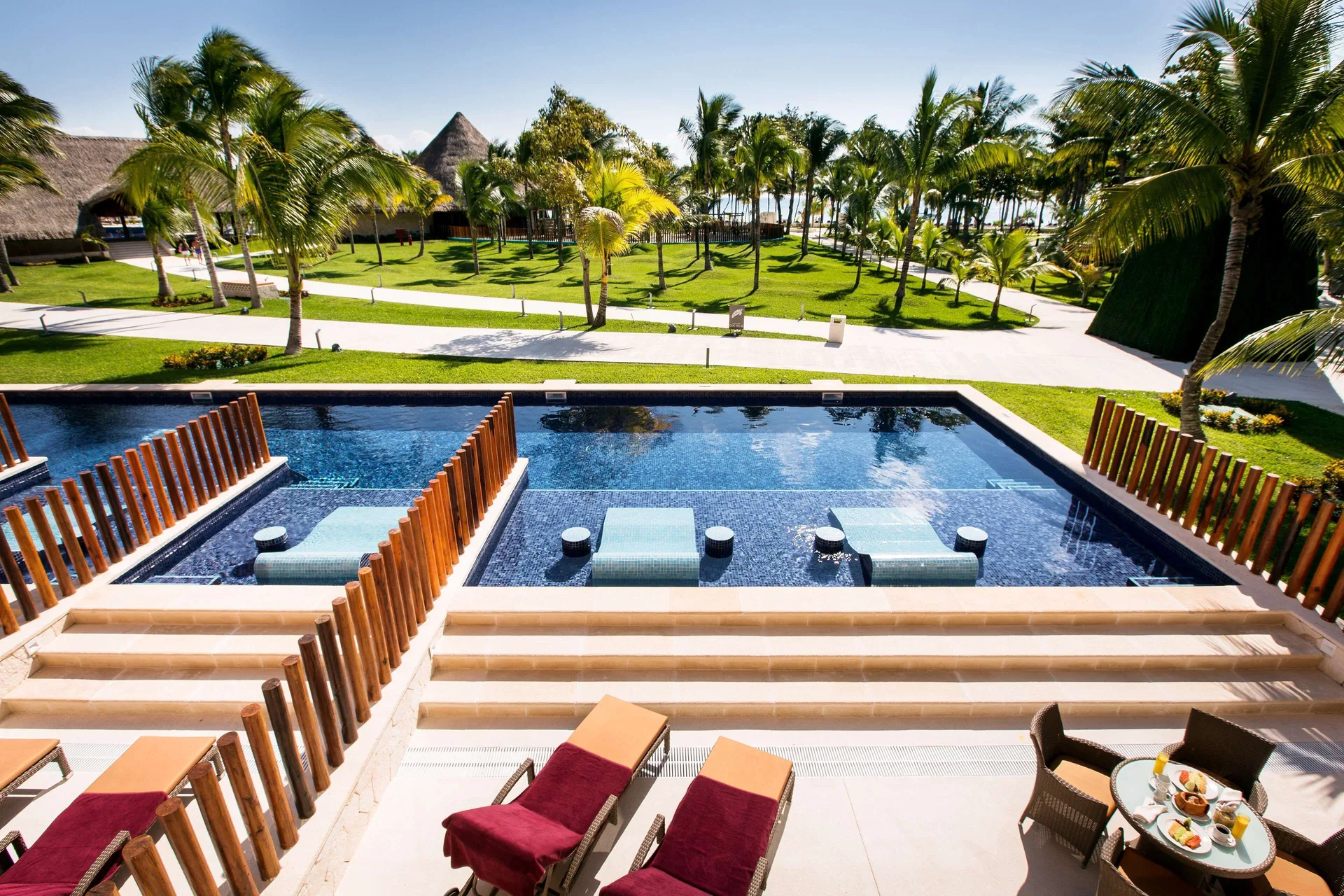 Swim-up suite terrace with loungers and pool view at Barceló Maya Caribe.