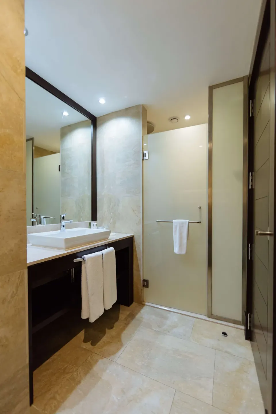 Superior Room bathroom with vanity and glass shower at Barceló Maya Caribe.