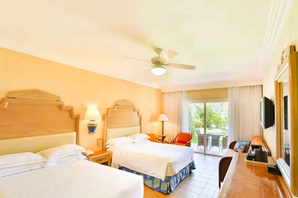 Superior Room with two beds and patio doors at Barceló Maya Caribe.