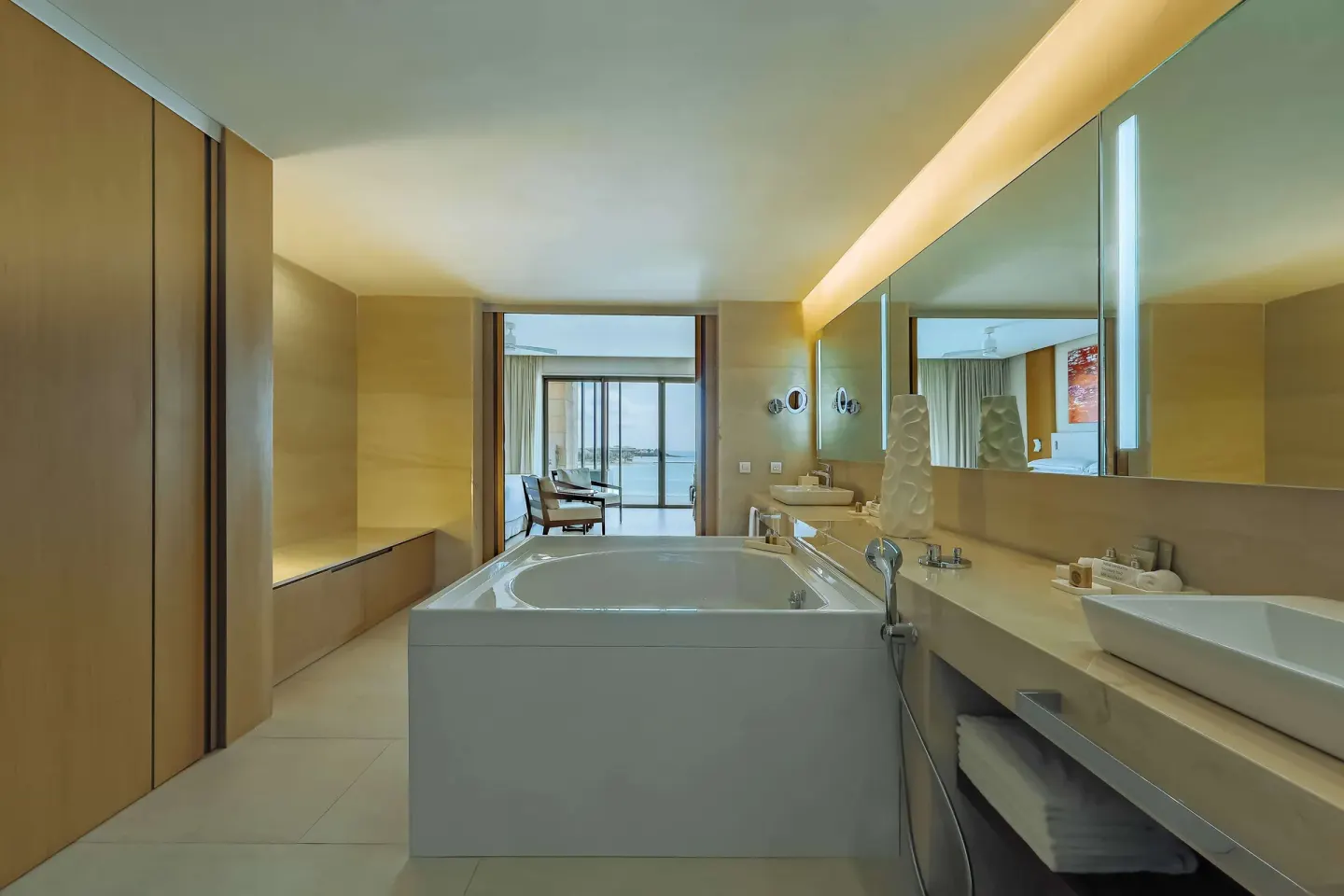 Guest bathroom with soaking tub, vanity, and ocean-facing room at Barceló Maya Riviera.