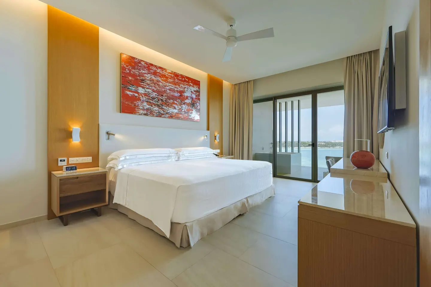 Guest room with king bed and balcony view at Barceló Maya Riviera.