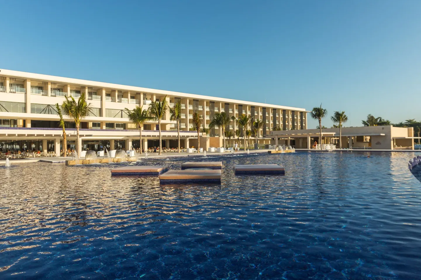 Large resort pool and guestroom building at Barceló Maya Riviera.