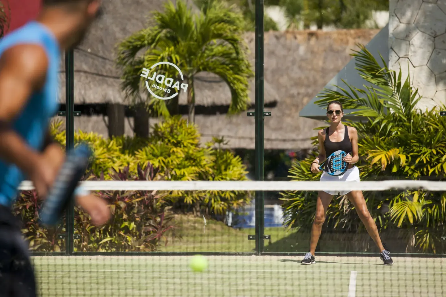 Guests play padel on an outdoor court at Barceló Maya Riviera.