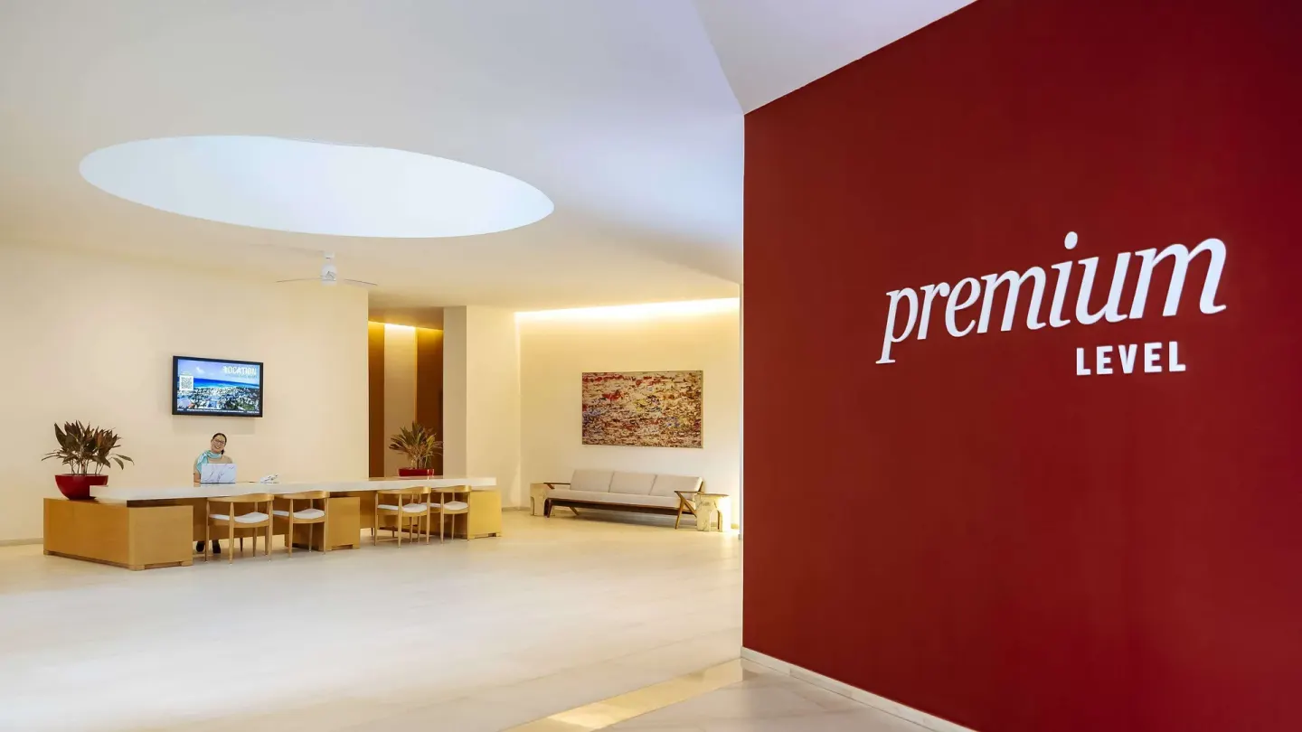 Premium Level reception area with red feature wall at Barceló Maya Riviera.