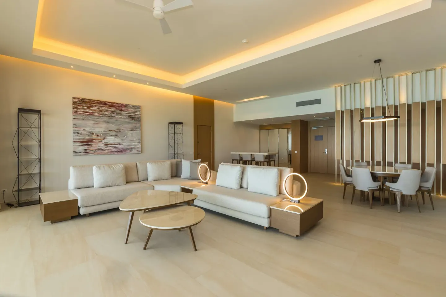 Suite living and dining area with sofas and pendant lighting at Barceló Maya Riviera.