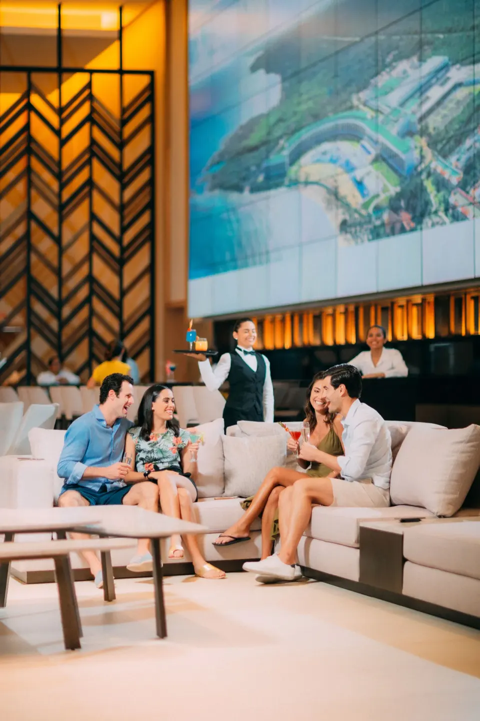 Guests seated with drinks in a lounge area at Barceló Maya Riviera.