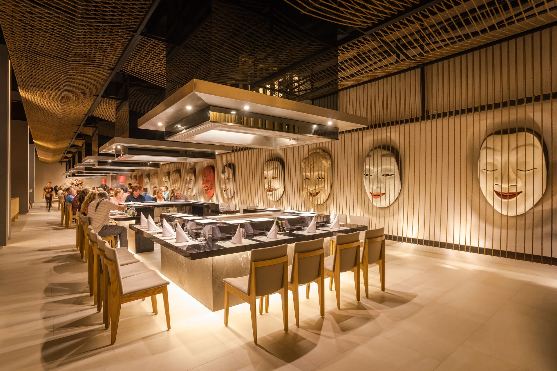 A teppanyaki-style dining counter with mask wall decor at Barceló Maya Riviera.