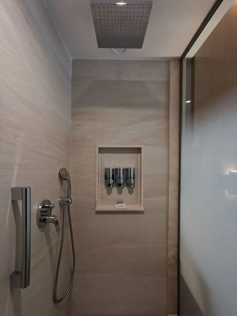 Junior Suite walk-in shower with rainfall head and dispensers at Barceló Maya Riviera.